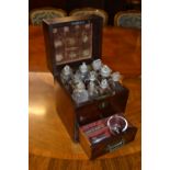 Small George III mahogany apothecary cabinet with a hinged cover enclosing glass bottles above a