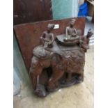 Eastern carved hardwood deep relief wall plaque in the form of figures riding an elephant