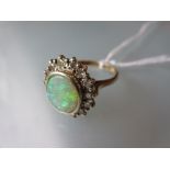 Oval opal and diamond cluster ring