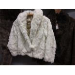 Ladies white fur jacket together with a quantity of other furs