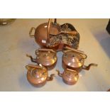 Antique copper helmet shaped coal scuttle and four 19th Century copper kettles