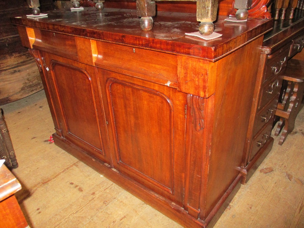 Victorian mahogany chiffonier with a shaped and carved back above two drawers and two cupboard