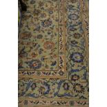 Tabriz carpet with an all-over palmette design predominantly in shades of blue on a pale ground,