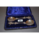 Pair of London silver cased serving spoons, the finials in the form of ' The Trusty Servant ',