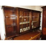 Reproduction mahogany side cabinet with two glazed doors flanked by open shelves together with a