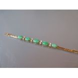 Far Eastern high carat yellow metal bracelet set five graduated oval green jade panels interspersed
