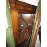 Reproduction mahogany standing corner cabinet with an astragal glazed door above a panelled door,