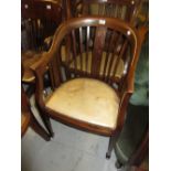 Edwardian mahogany tub shaped drawing room chair with a padded leather seat on square tapered