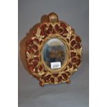 Gilt metal rococo style dressing table mirror on velvet backing with easel