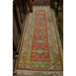 Modern Turkish runner with geometric designs on a terracotta ground with borders