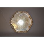 London silver salver with a shaped rim and all-over engraved decoration CONDITION REPORT