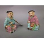 Pair of Chinese porcelain figures of seated children,