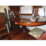 Reproduction mahogany circular pedestal extending dining table together with a similar mahogany and