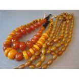 Three amber coloured bead necklaces