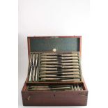 A MAHOGANY CUTLERY BOX with three lift-out trays, fitted with thirty three Old English thread