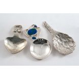 THREE CONTEMPORARY CADDY SPOONS:- An eagle's wing, hallmarked Sheffield 1987, a spoon with an