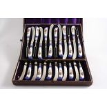 A 19TH CENTURY CASED SET OF TWELVE PAIRS OF PLATED DESSERT KNIVES & FORKS with Continental porcelain