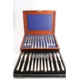 A VICTORIAN CASED SET OF SIX PAIRS OF FISH KNIVES & FORKS with loaded handles, decorated with