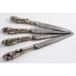 FOUR CAST 18TH CENTURY DUTCH KNIFE HANDLES in the form of a rampant lion with a shield (one