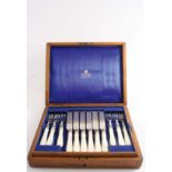 A VICTORIAN CASED SET OF TWELVE PAIRS OF PLATED DESSERT KNIVES & FORKS with engraved decoration