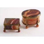 A LATE 19TH CENTURY GILT METAL MOUNTED, BANDED AGATE CASKET oval with reeded borders and four ball