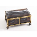 A LATE 19TH CENTURY GILT-METAL MOUNTED BANDED AGATE CASKET of plain rectangular form on four ball