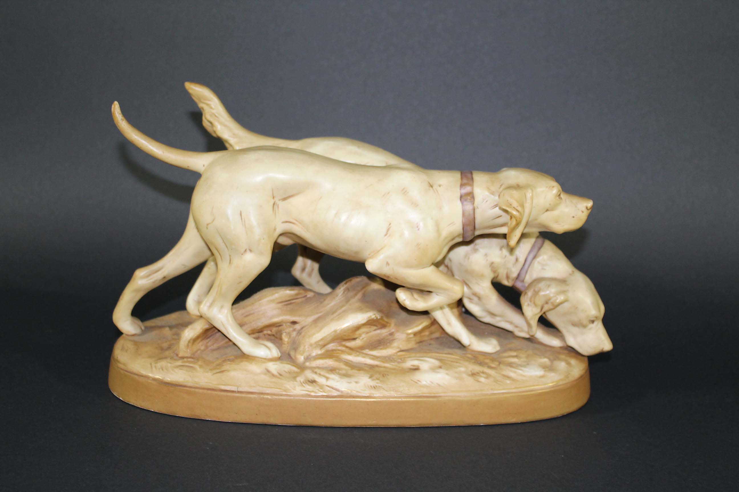 ROYAL DUX GROUP - GUN DOGS a pair of Gun Dogs on the scent, mounted on an oval base. Triangle mark