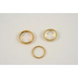 A 22CT. GOLD WEDDING BAND 4.9 grams, size M, together with another 22ct. gold wedding band, 1.9