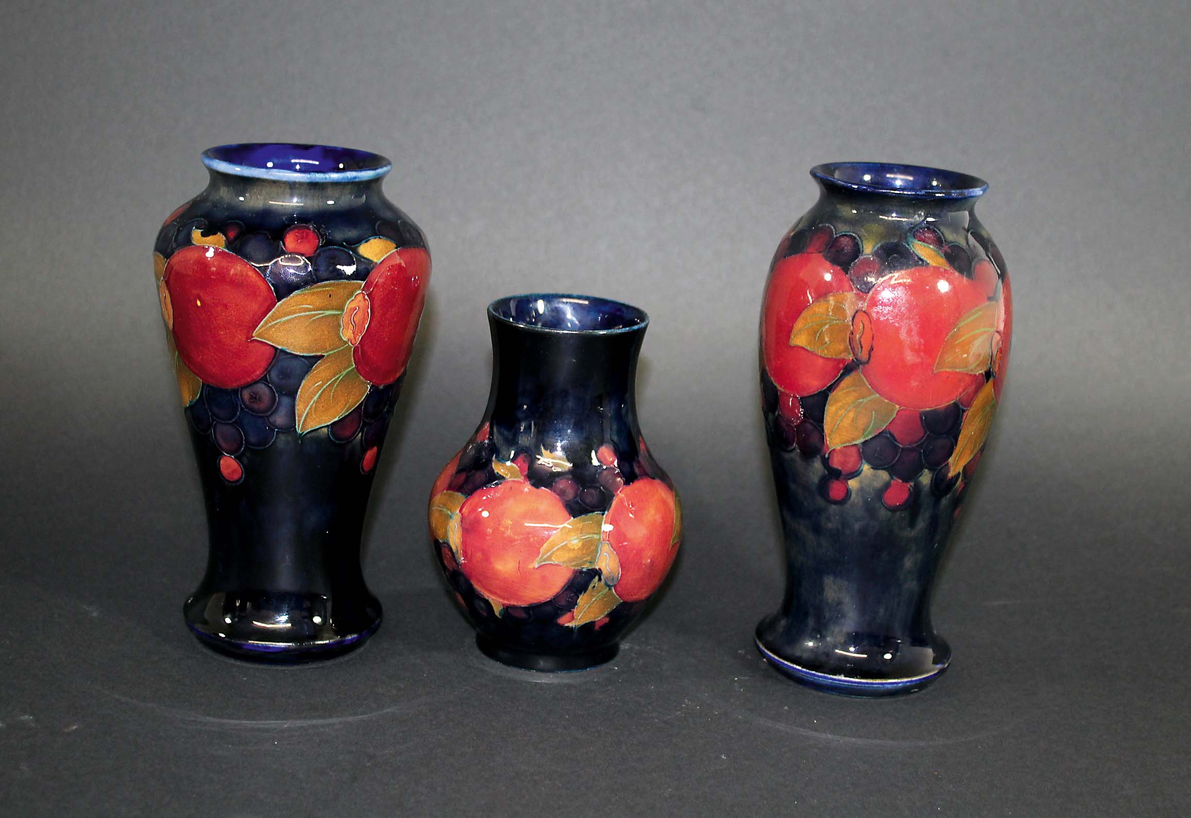 MOORCROFT VASES three Moorcroft vases in the Pomegranate design, the largest vase with