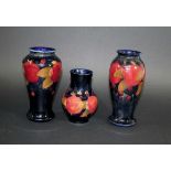 MOORCROFT VASES three Moorcroft vases in the Pomegranate design, the largest vase with