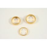 A 22CT. GOLD WEDDING BAND 11.7 grams, size U, a 22ct. gold wedding band, 10.1 grams, size O 1/2, and