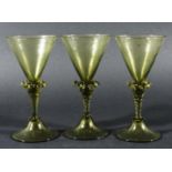 SET OF EIGHT VENETIAN STYLE WINE GLASSES, pale olive green, the conical bowls with wrythen