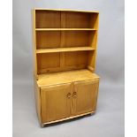 ERCOL BOOKCASE a light coloured elm bookcase from the Windsor Range, the top section with two