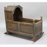 OAK CRADLE, probably 19th century, with fielded panel sides, height 83cm, width 91cm, depth 43cm