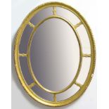 REGENCY STYLE GILT OVAL WALL MIRROR, 19th century, the central bevelled glass inside a mirrored