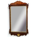 GEORGE II WALNUT AND PARCEL GILT WALL MIRROR, the rectangular plate inside a gently scrolling
