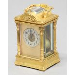 FRENCH GILT BRASS FOUR PANE CARRIAGE CLOCK, the silvered dial with arabic numerals and foliate