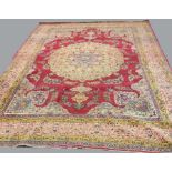 KIRMAN CARPET, South East Iran, the central floral rosette on a burgundy ground with floral swags