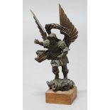 EBONISED CARVING OF ST MICHAEL, standing holding out his right arm, halo above and wings spread,