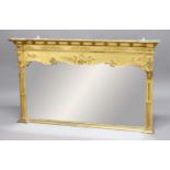 REGENCY STYLE GILT OVERMANTEL MIRROR, the shaped rectangular plate beneath a scrolling frieze and