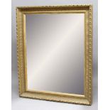 LARGE GILT FRAMED WALL MIRROR, the rectangular bevelled glass plate inside a fluted and twisting