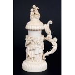 GERMAN IVORY TANKARD, 19th century, carved with children musicians and hunters, the hinged covers