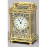 FRENCH BRASS AND CHAMPLEVE FOUR PANE CARRIAGE TIMEPIECE, the ivorine dial in a foliate border, on