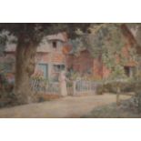 THOMAS NICHOLSON TYNDALE (1860-1930) LADY AT A COTTAGE GATE, CHIPPING CAMPDEN, OXFORDSHIRE Signed,