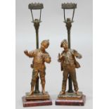 PAIR OF BRONZED SPELTER FIGURAL LAMPS, early 20th century, modelled as street boys before a lamp, on