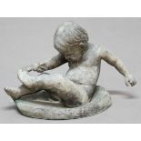 LEAD GARDEN FIGURE, cast as a young child pulling their sock off, height 22cm, width 32cm