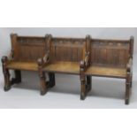 VICTORIAN OAK GOTHIC SETTLE, in the manner of Pugin, the three seats with floral carved top rail,