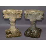 PAIR OF LIMESTONE URNS, possibly 17th century, perhaps originally finials, carved with stiff leaf