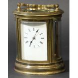 OVAL GILT BRASS FOUR PANE CARRIAGE TIME PIECE the enamelled dial on a brass, four pillar movement