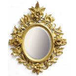 FLORENTINE GILTWOOD MIRROR, perhaps late 18th century, the bevelled, oval plate inside a frame